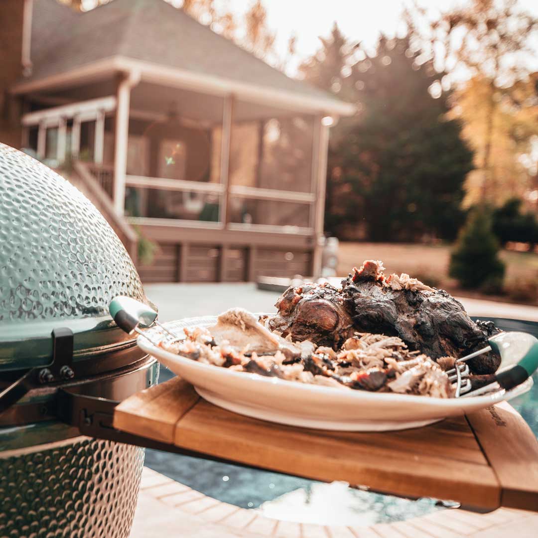 Pulled Pork on white plate on Big Green Egg Acacia MateEgg A