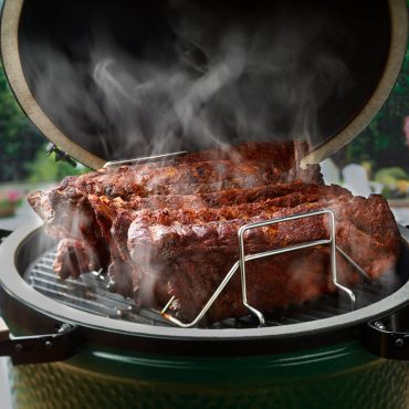 Ribs in rib rack smoking on Big Green Egg